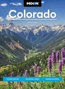 Image of mountainous valley with purple flowers in foreground and text reading Moon Colorado